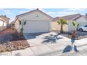 House exterior showcasing a two-car garage and desert landscaping at 4634 Skybolt St, Las Vegas, NV 89115