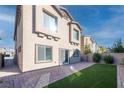 Landscaped backyard with artificial turf and paved patio at 487 Via Renata, Henderson, NV 89044