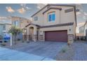 Two-story house with attached garage and brick driveway at 487 Via Renata, Henderson, NV 89044