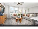Bright and airy great room with comfortable seating and large windows at 6106 Garden Oasis St # Lot 1, Las Vegas, NV 89148