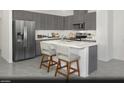 Modern kitchen with gray cabinets and stainless steel appliances at 6106 Garden Oasis St # Lot 1, Las Vegas, NV 89148