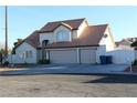 Two-story house with three-car garage and terracotta roof at 6701 Willow River Ct, Las Vegas, NV 89108