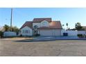 Two-story house with three-car garage and terracotta roof at 6701 Willow River Ct, Las Vegas, NV 89108