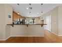Bright, airy kitchen with breakfast bar, wooden floors, and seamless access to the outdoor area at 9331 Hilgard Ave, Las Vegas, NV 89178