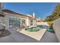 Kidney-shaped pool with a spa, surrounded by a patio at 1612 Indian Cove Ln, Las Vegas, NV 89128