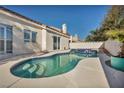 Kidney-shaped swimming pool with a spa and a turquoise-colored planter at 1612 Indian Cove Ln, Las Vegas, NV 89128