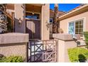 Elegant house entrance with a decorative gate and landscaping at 2145 Sierra Heights Dr, Las Vegas, NV 89134