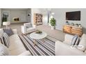 Virtually staged living room featuring comfy sofas, a coffee table, and built-in shelving at 2736 Taylor Ave, North Las Vegas, NV 89030