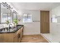 Updated bathroom with double vanity, walk-in shower, and dark countertop at 3517 Spencer St, Las Vegas, NV 89169