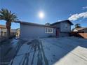 Gray house with red door and a palm tree in front at 5337 Hacienda Cir, Las Vegas, NV 89120