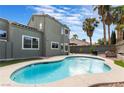Relaxing kidney-shaped pool surrounded by a spacious patio at 6112 Browning Way, Las Vegas, NV 89130