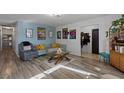 Living room with hardwood floors, comfy couch, and eclectic decor at 6214 Gunderson Blvd, Las Vegas, NV 89103