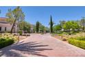 Brick-paved road leads to a gated community entrance with manicured landscaping at 66 Innisbrook Ave, Las Vegas, NV 89113