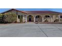 House exterior featuring a red tile roof and arched entryway at 8870 W Craig Rd, Las Vegas, NV 89129