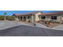 Ranch-style home with a long driveway and desert landscaping at 8870 W Craig Rd, Las Vegas, NV 89129
