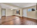 Bright and airy living room featuring neutral paint, hardwood floors and plentiful natural light from the windows at 111 Manganese St, Henderson, NV 89015