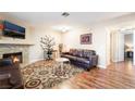 Cozy living room with fireplace, leather sofa, and decorative rug at 1321 Cinder Rock Dr # 202, Las Vegas, NV 89128