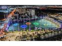 Aerial view of illuminated Topgolf Las Vegas at night at 135 E Harmon Ave # 3416, Las Vegas, NV 89109