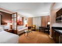Bright suite living room with sofa, chairs, and kitchenette at 135 E Harmon Ave # 3416, Las Vegas, NV 89109