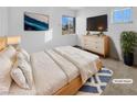 Bright bedroom with a large bed, dresser, and TV at 1819 Bassler St, North Las Vegas, NV 89030