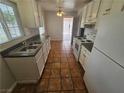 Bright kitchen with white cabinets, tiled floor, and stainless steel appliances at 2208 W Washington Ave, Las Vegas, NV 89106
