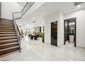 Elegant entryway with modern staircase and powder room at 2824 Queens Courtyard Dr, Las Vegas, NV 89109