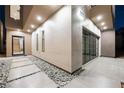 Modern home exterior with sleek lines and a stone facade at 2824 Queens Courtyard Dr, Las Vegas, NV 89109
