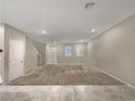 Bright and airy living room with neutral carpeting and tile flooring at 3206 Brynley Ave, Henderson, NV 89044