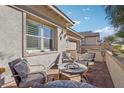 Brick patio with fire pit and comfortable seating for outdoor relaxation at 335 Alto Avec Ln, Henderson, NV 89011