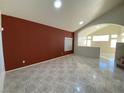 Open living area with high ceilings, tile floors, and a red accent wall at 4355 Sunrise Shores Ave, North Las Vegas, NV 89031