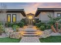 Elegant entryway with a modern gate and stone pathway at 8075 Palm Cove Ct, Las Vegas, NV 89129