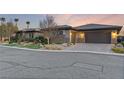 Modern home with attached garage and desert landscaping at 8075 Palm Cove Ct, Las Vegas, NV 89129