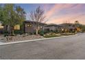 Contemporary home with stone accents and lush landscaping at 8075 Palm Cove Ct, Las Vegas, NV 89129