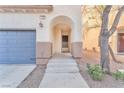 Front entry with arched doorway and steps leading to the home at 1172 Via Ponte, Henderson, NV 89052