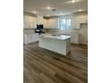 Spacious kitchen boasts an island, stainless steel appliances, and ample white cabinetry at 1433 Nocturnal Flight St, Las Vegas, NV 89138