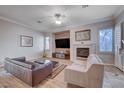 Comfortable living room with fireplace and ample natural light at 2428 Granada Bluff Ct, Las Vegas, NV 89135