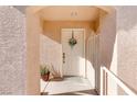 Front entrance with a white door, wreath, and potted plant at 3950 S Sandhill Rd # 110, Las Vegas, NV 89121