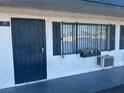 Apartment building entrance with a dark-grey door and window with shutters at 4600 University Center Dr # 95, Las Vegas, NV 89119
