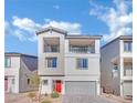 Two-story house with gray siding, red door, and gray garage door at 5566 Erindale Terrace Ave, Las Vegas, NV 89141