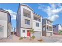 Two-story house with gray siding, red door, and gray garage door at 5566 Erindale Terrace Ave, Las Vegas, NV 89141