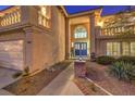 Two-story house entrance with brick walkway and blue door at 9304 Angelfish Dr, Las Vegas, NV 89117