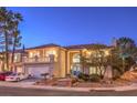 Two-story house with balcony, landscaped yard, and two-car garage at 9304 Angelfish Dr, Las Vegas, NV 89117