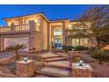 Two-story house with balcony, landscaped yard, and two-car garage at 9304 Angelfish Dr, Las Vegas, NV 89117