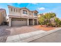 Two-story house with attached garage and landscaped front yard at 10529 Parthenon St, Las Vegas, NV 89183