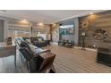 Modern living room features luxury vinyl flooring, recessed lighting, and a large sectional sofa at 10529 Parthenon St, Las Vegas, NV 89183