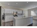 Modern kitchen with white cabinets and large island at 1067 Garden Cress Ct, Las Vegas, NV 89138