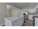 Modern kitchen with white cabinets and large island at 1067 Garden Cress Ct, Las Vegas, NV 89138