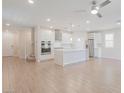 Modern kitchen featuring white cabinets, stainless steel appliances, and an island at 10718 Glowing Dawn Ave, Las Vegas, NV 89135