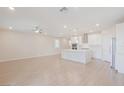 Bright kitchen with an island, white cabinets and stainless steel appliances at 10718 Glowing Dawn Ave, Las Vegas, NV 89135