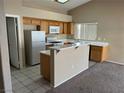 Kitchen features light wood cabinets, and a breakfast bar at 118 Queenswreath Dr, North Las Vegas, NV 89031